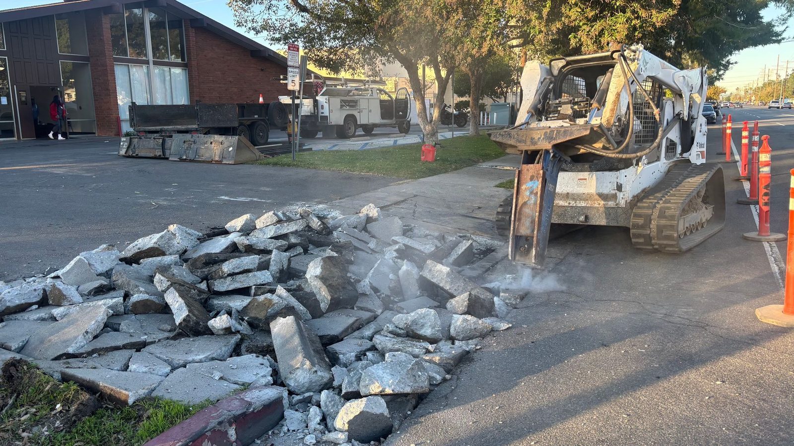 Bobcat T770 with hydraulic breaker breaking out a commercial parking lot