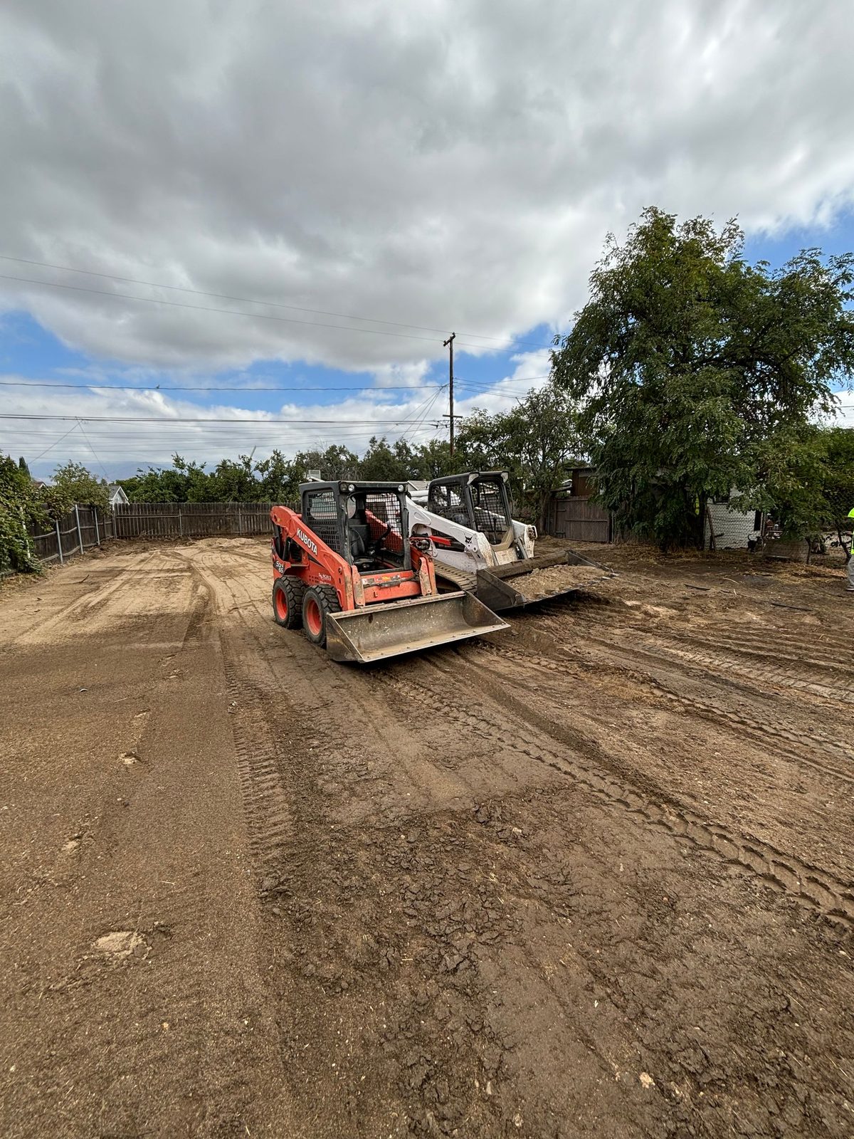 Skid steer grading a residential lot