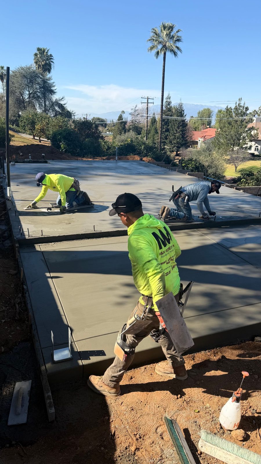 Crew finishing a freshly poured ADU slab