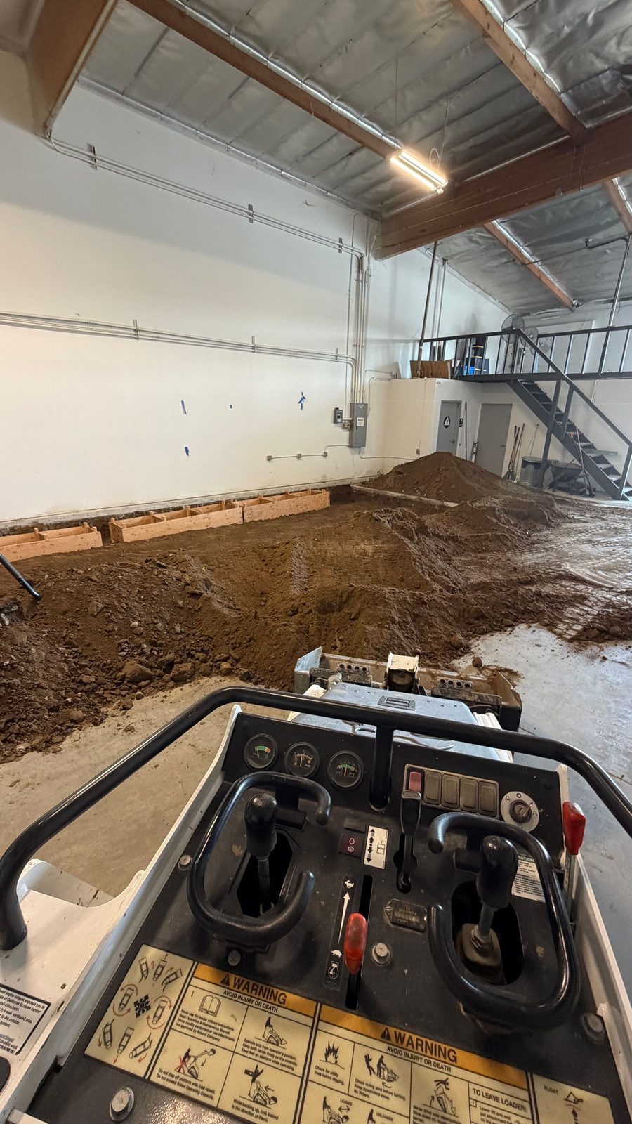 Excavating inside a warehouse with the mini track loader