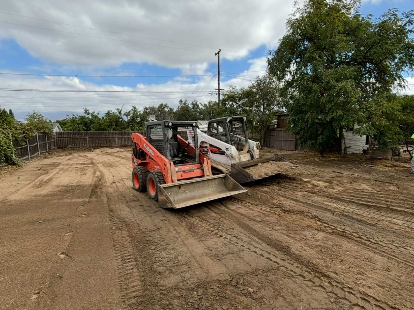 Track loader cutting a residential pad to grade